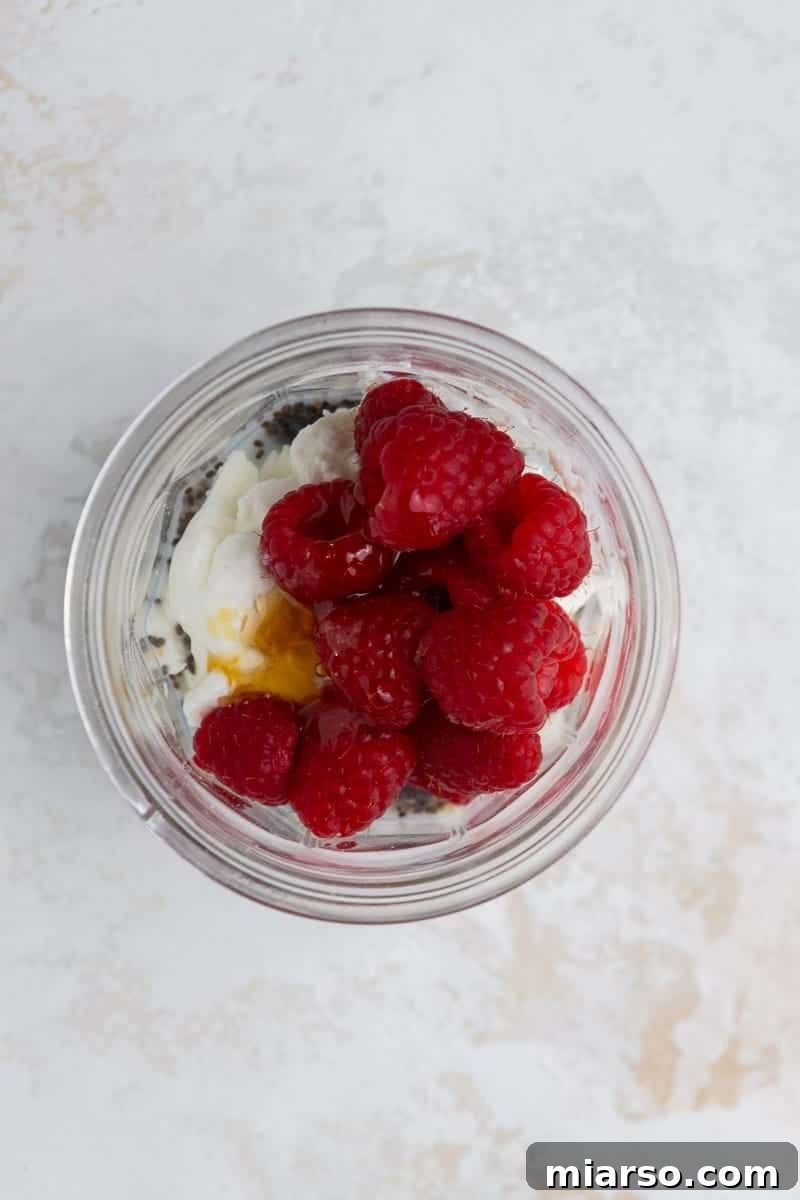 Mixing oats and ingredients in a cup for overnight oats.