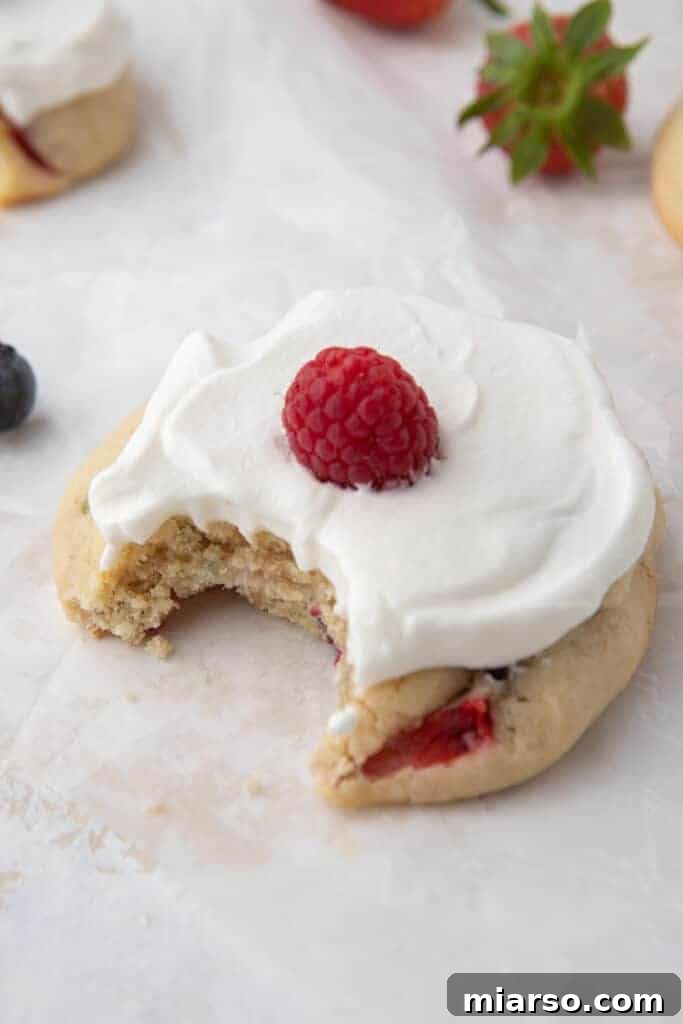 A single mini Crumbl Berries and Cream Cookie with whipped cream