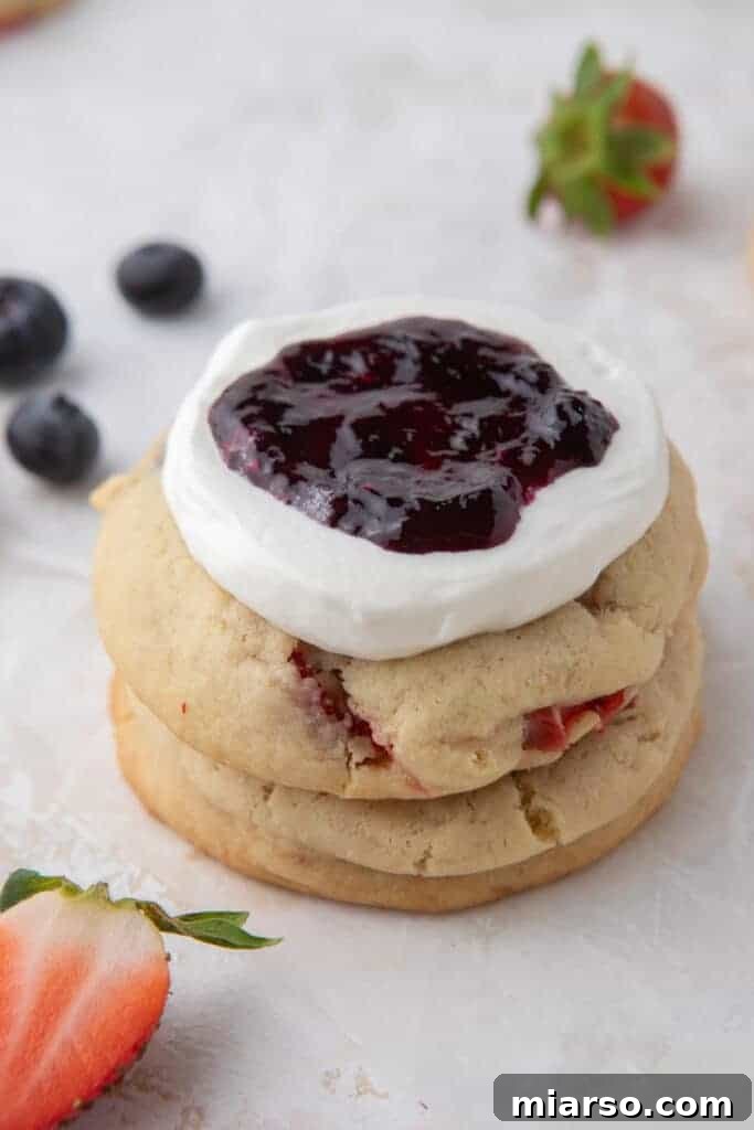 Close-up of Crumbl Berries and Cream Cookies with fresh raspberries