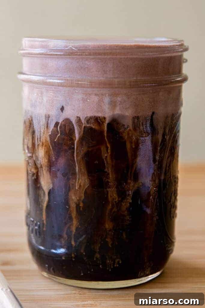 Mastering Starbucks Chocolate Cream Cold Brew at Home 2 Close up view of a tall glass filled with Starbucks Chocolate Cream Cold Brew, garnished with chocolate cream foam