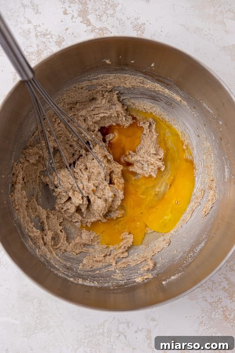 Creamed butter and sugar in a mixing bowl, showing the initial stage of cookie dough preparation.