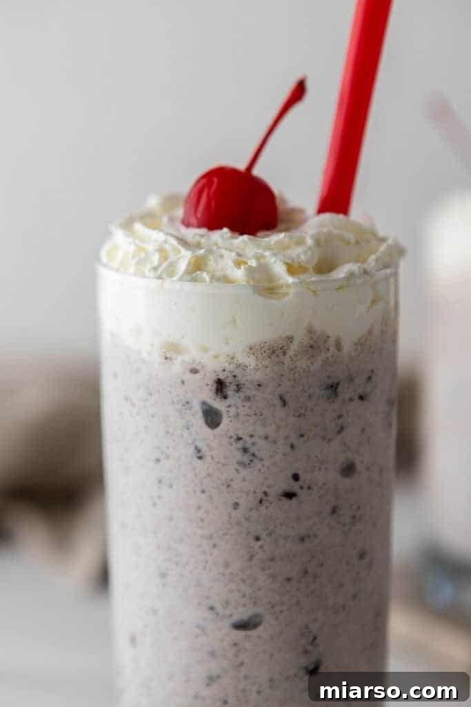 Oreo milkshake with whipped cream and a cherry