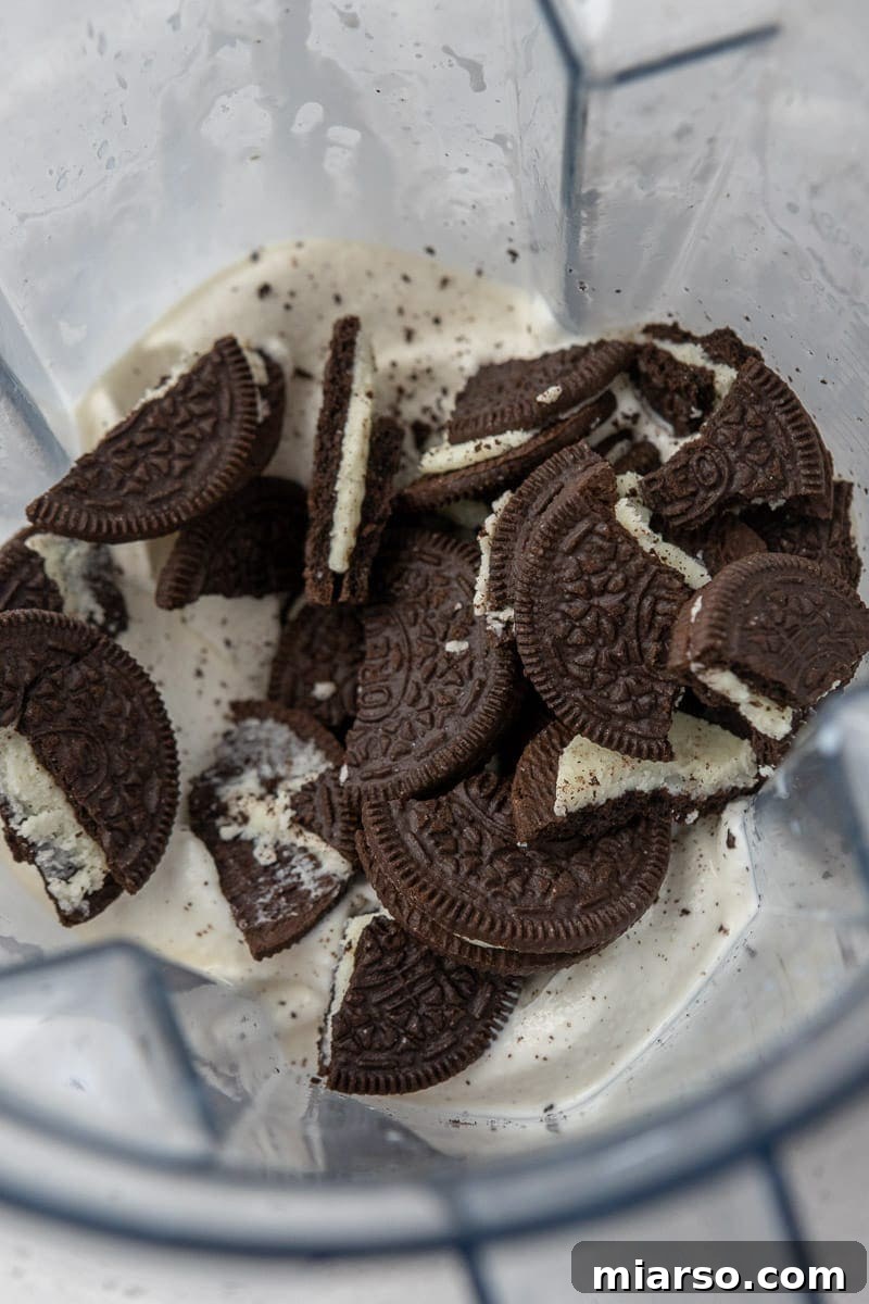 Ice cream and oreos being blended for a milkshake