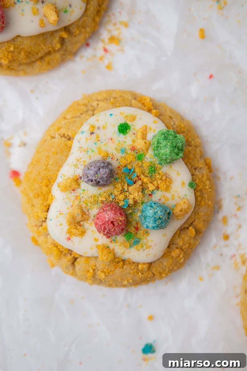 Homemade Crumbl Berry Crunch Cookie Perfection 11 Completed Berry Crunch cookie, glazed and topped with colorful cereal.