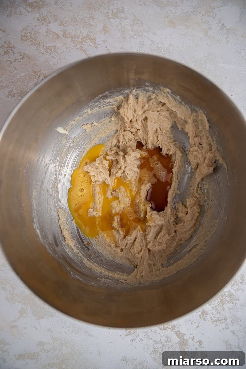 Homemade Crumbl Berry Crunch Cookie Perfection 5 Creamed butter and sugar in bowl, a foundational step for the cookie dough.