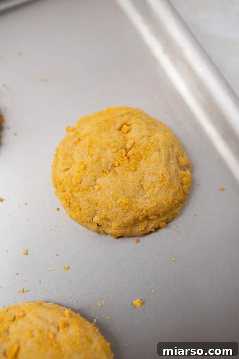 Homemade Crumbl Berry Crunch Cookie Perfection 10 Freshly baked cookie on a baking sheet, showing its golden edges and soft center.