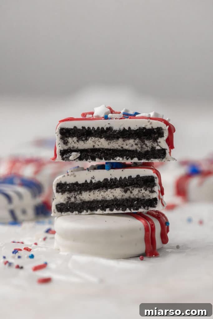 Red, White, & Blue Oreo Delights 4 A stack of beautifully decorated 4th of July Oreo cookies, showcasing the red, white, and blue drizzles and sprinkles.