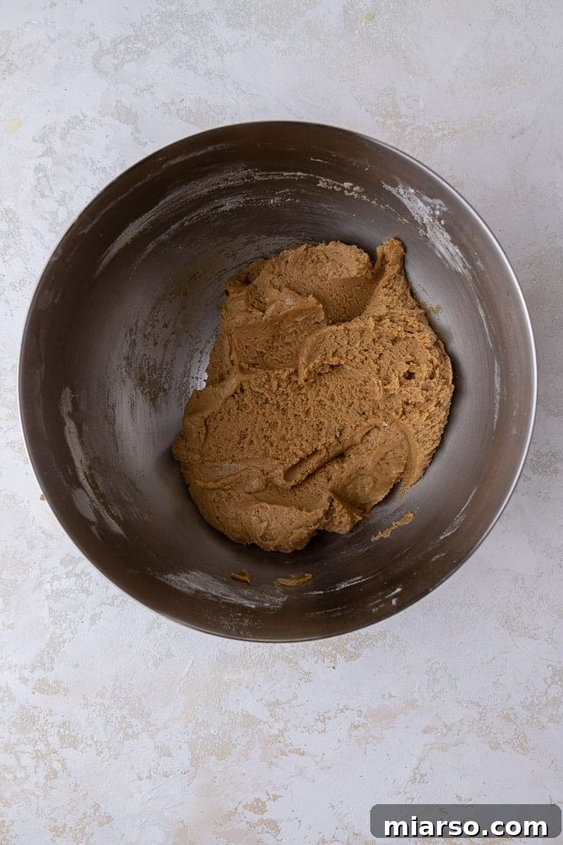 Crumbl Cookie Butter Cookie Crunch Ice Cream 6 Bowl of brown sugar cookie dough, showing its rich color and texture before baking