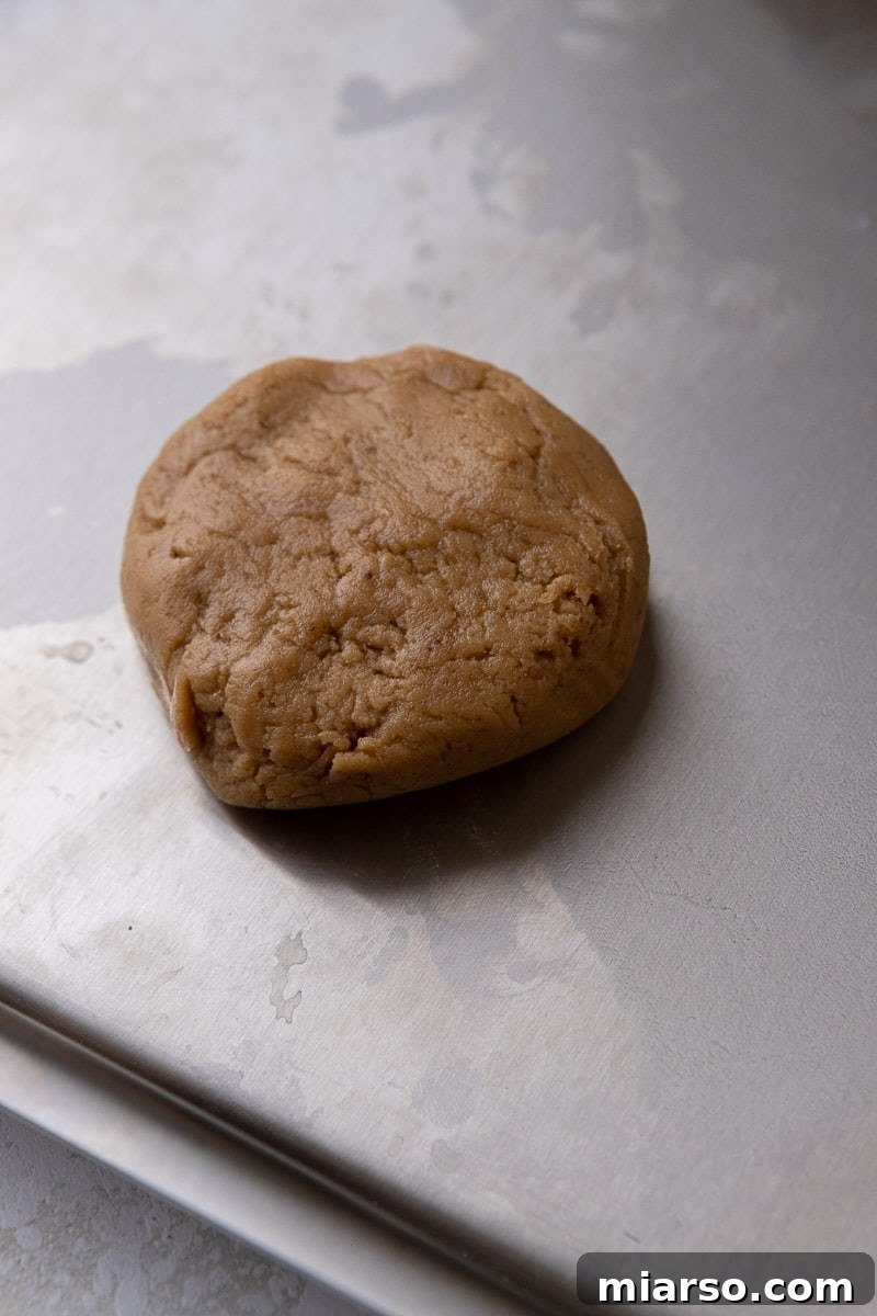 Crumbl Cookie Butter Cookie Crunch Ice Cream 7 Scooped brown sugar cookie dough balls on a baking sheet, ready for the oven