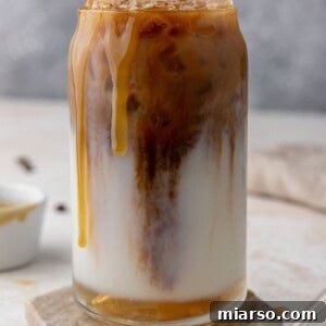Starbucks Inspired Homemade Iced Caramel Macchiato 11 A beautifully crafted Starbucks caramel iced macchiato, showing the layers.