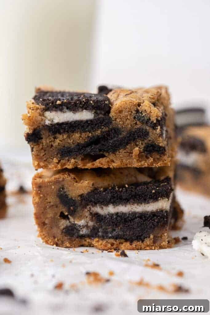 Decadent Oreo Blondie Delights 2 Stacked Oreo blondies, showcasing their fudgy texture and Oreo chunks
