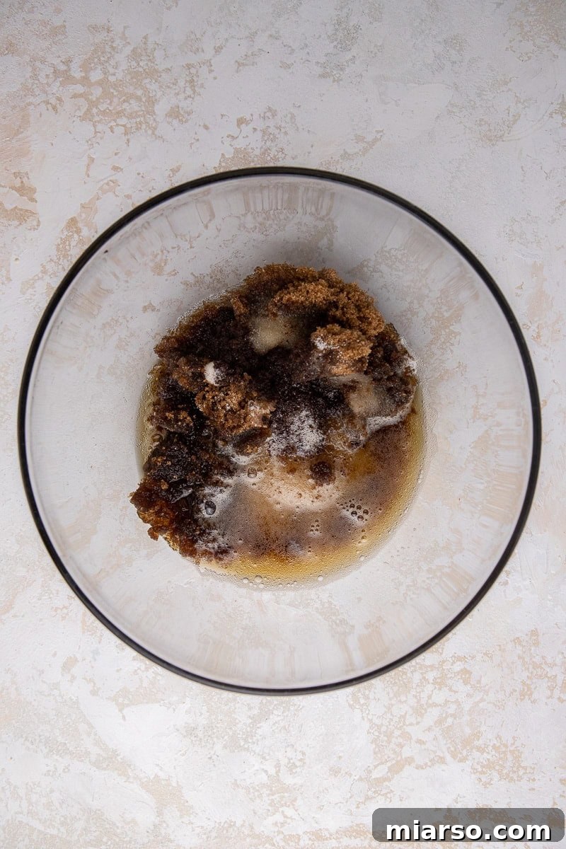 Decadent Oreo Blondie Delights 4 Butter and sugar in a bowl being mixed for blondies