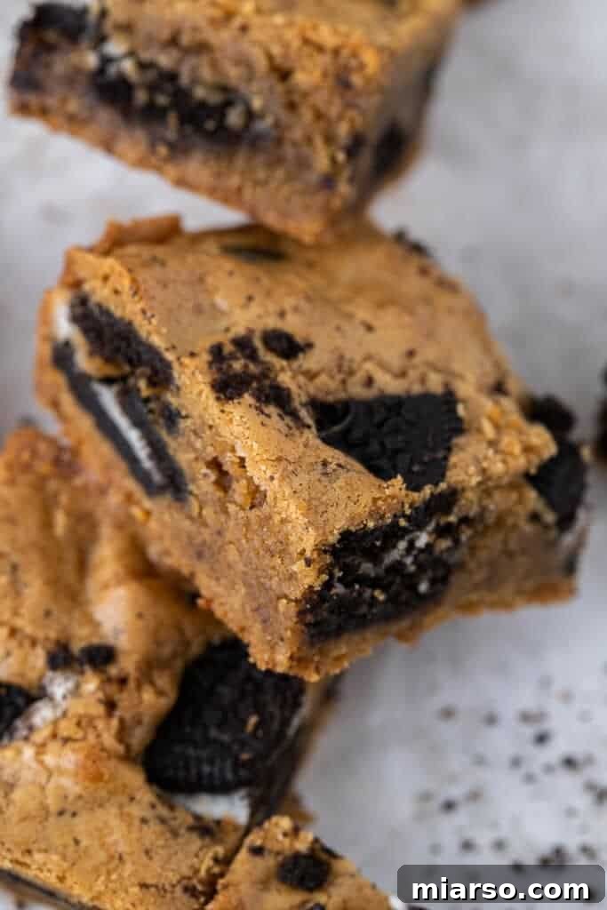 Decadent Oreo Blondie Delights 9 A single square of brown butter Oreo blondie on a plate