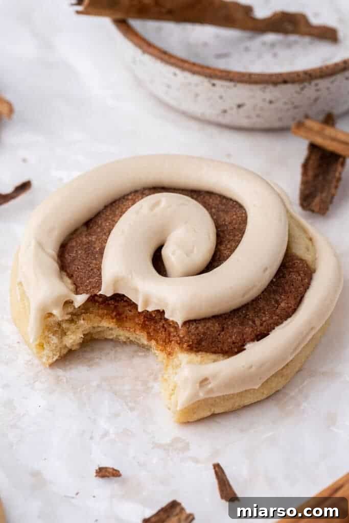 Homemade Crumbl Maple Cinnamon Roll Cookies with maple cream cheese frosting