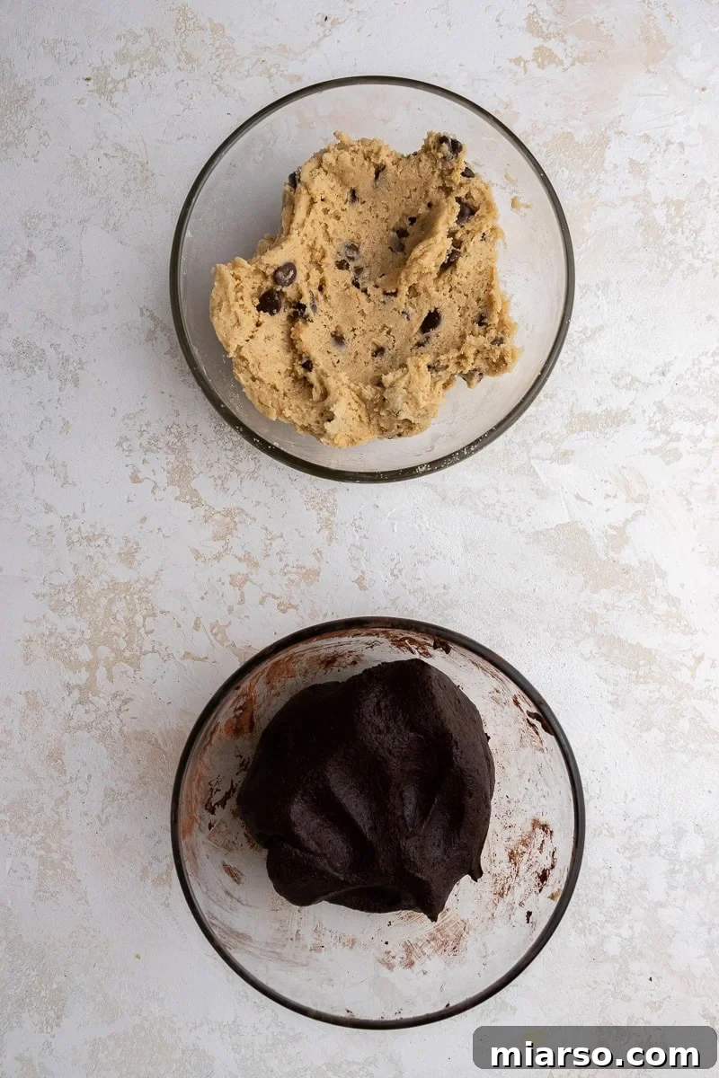 Two bowls of cookie dough, chocolate and graham cracker flavor