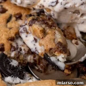 Effortless Giant Oreo Skillet Cookie 11 Close up of a warm cookies and cream skillet cookie topped with melting ice cream.
