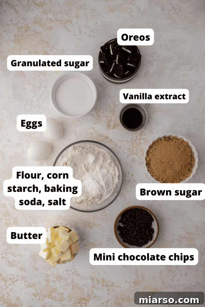 Effortless Giant Oreo Skillet Cookie 3 A flat lay photograph showcasing all the fresh ingredients needed to bake the cookies and cream skillet cookie, including butter, sugars, flour, eggs, vanilla, Oreos, and chocolate chips.