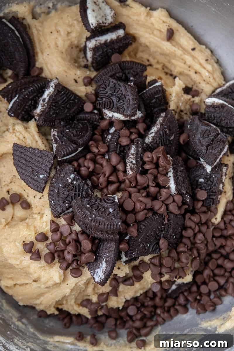 Effortless Giant Oreo Skillet Cookie 5 Cookie dough with chocolate chips and chopped Oreos folded in, ready to be spread into the skillet.