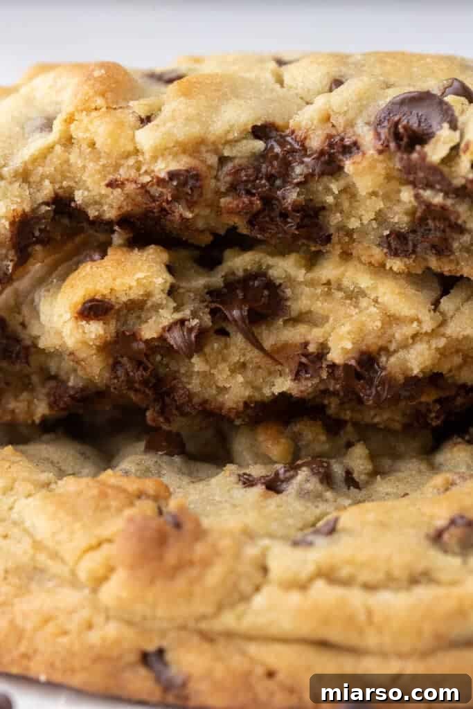 Unlock the Secret to Your Perfect Single Serve Chocolate Chip Cookie 11 Close up of a pile of freshly baked chocolate chip cookies, showcasing their rich texture and melty chocolate.