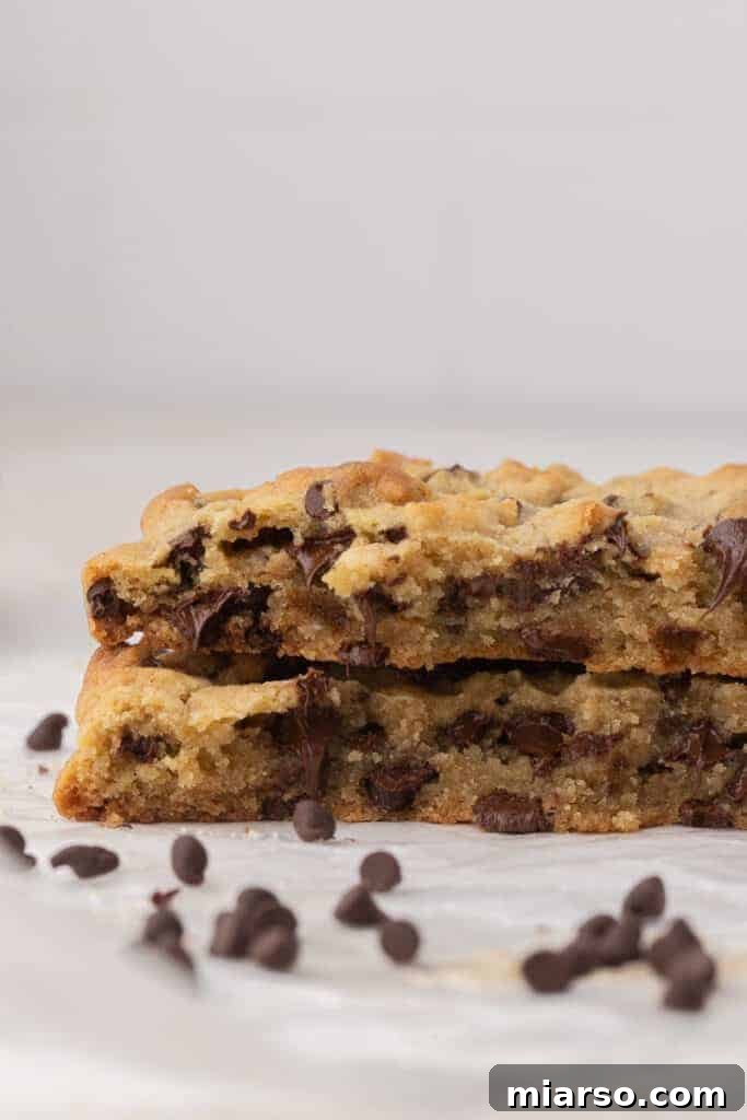 Unlock the Secret to Your Perfect Single Serve Chocolate Chip Cookie 4 A stacked chocolate chip cookie broken in half, revealing its gooey, melty chocolate center.
