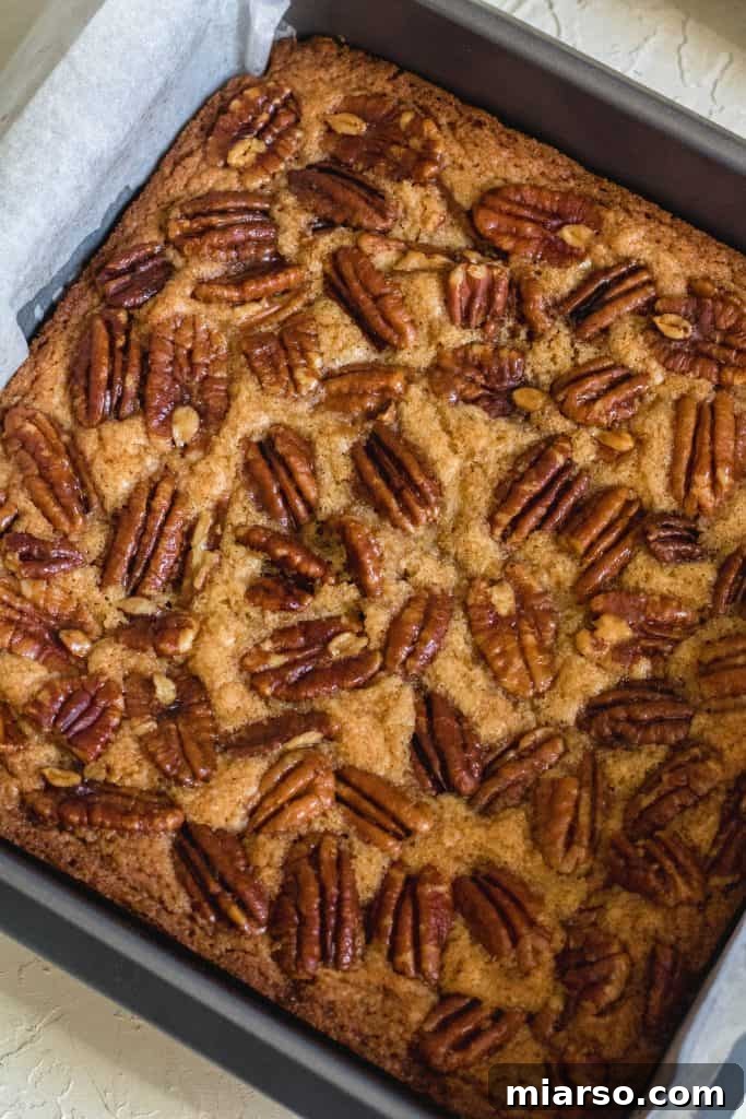 Baked pecan brown butter blondies fresh out of the oven, golden and fragrant.