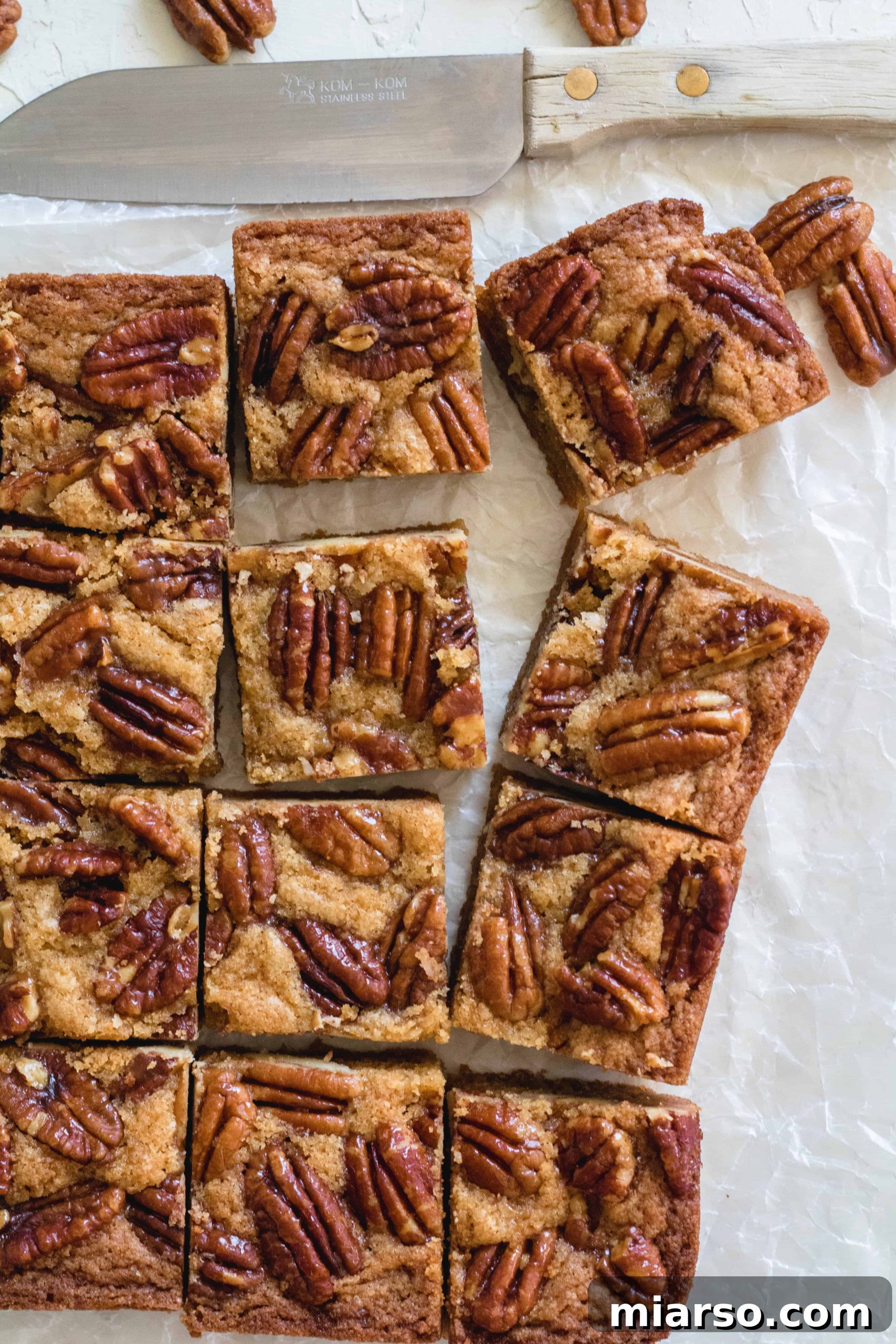 Perfectly sliced brown butter candied pecan blondies, ready to be served.