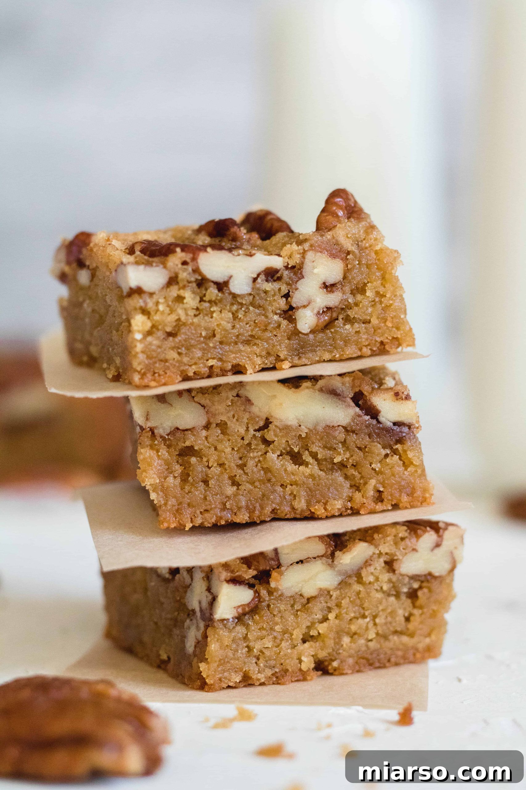 A close-up of the best brown butter blondies in the world, showing their perfect golden crust.