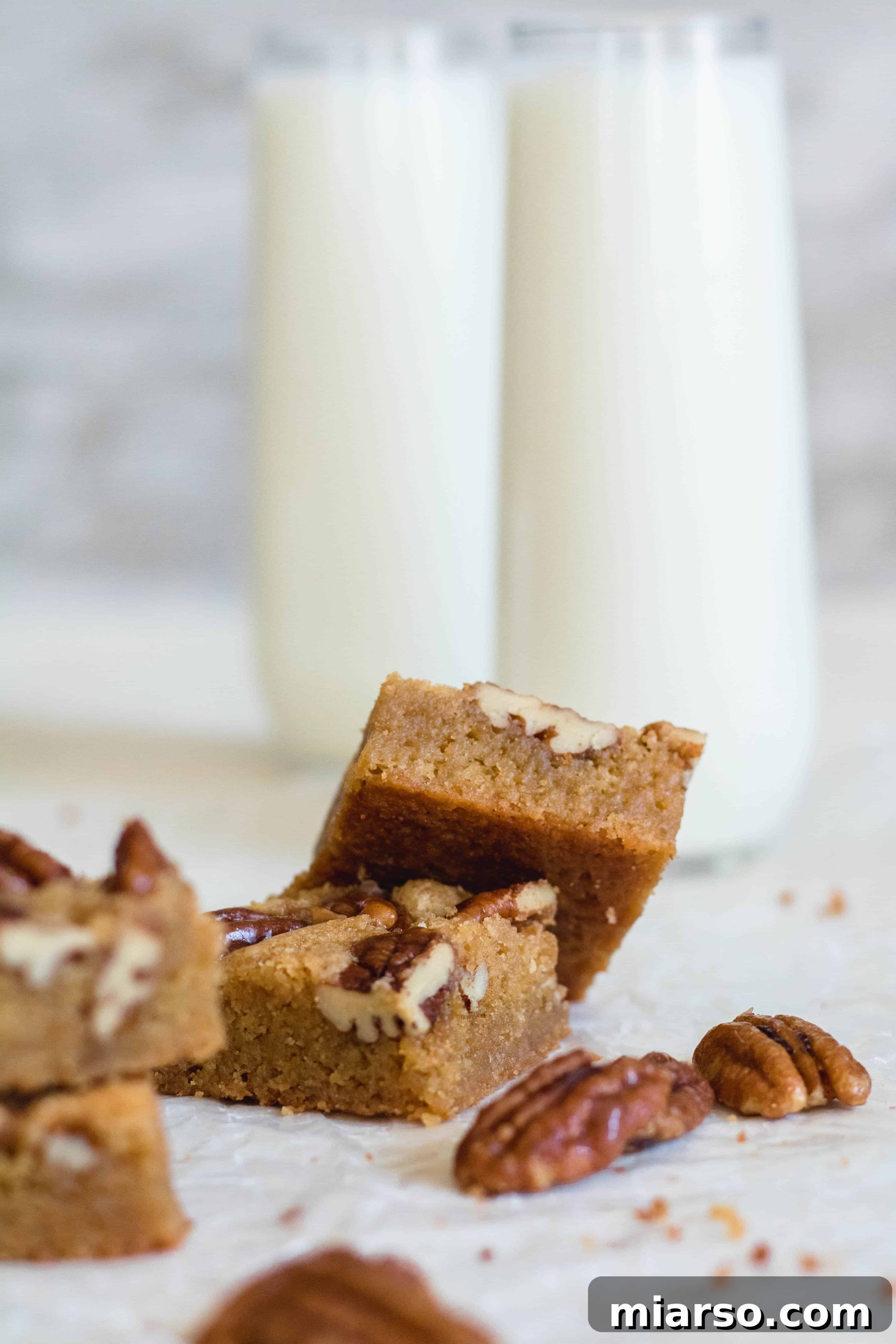 A stack of super chewy brown butter blondies, highlighting their dense, moist texture.