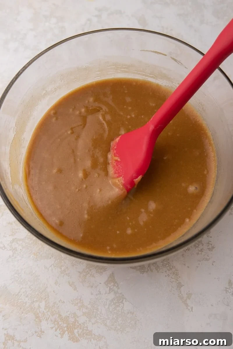 Close-up of the smooth, amber-colored peanut butter and syrup mixture.
