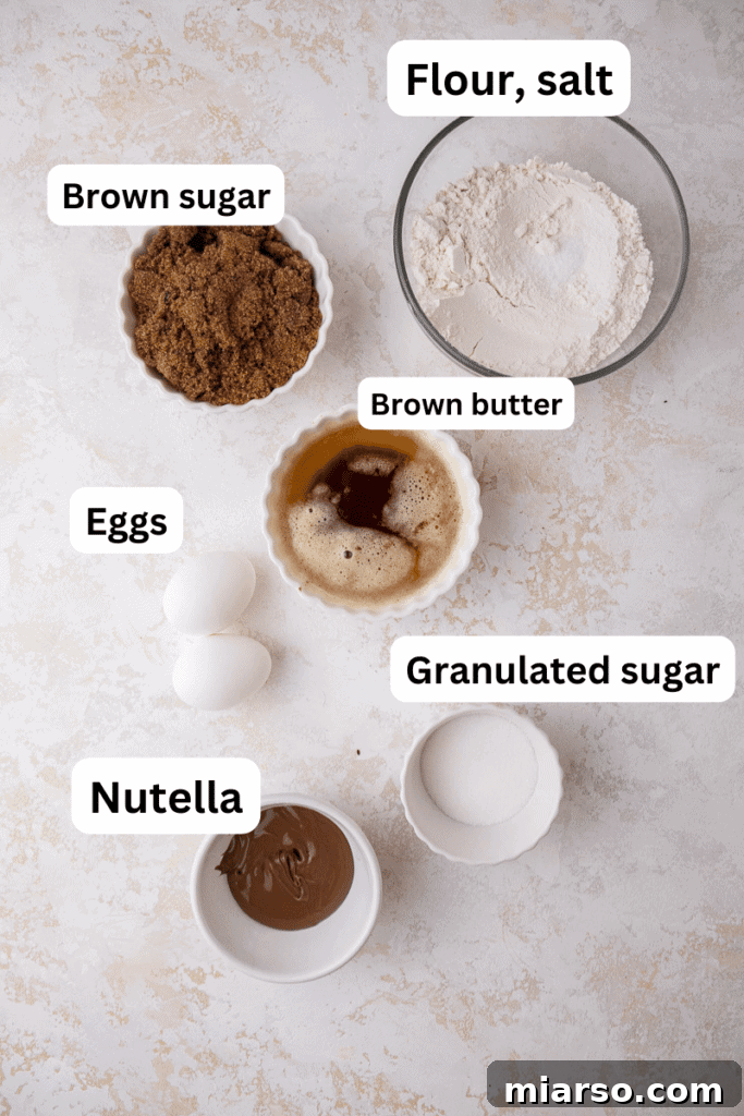 Decadent Nutella Swirl Blondies 3 Essential ingredients for baking easy and delicious Nutella blondies, including butter, sugars, eggs, flour, and Nutella