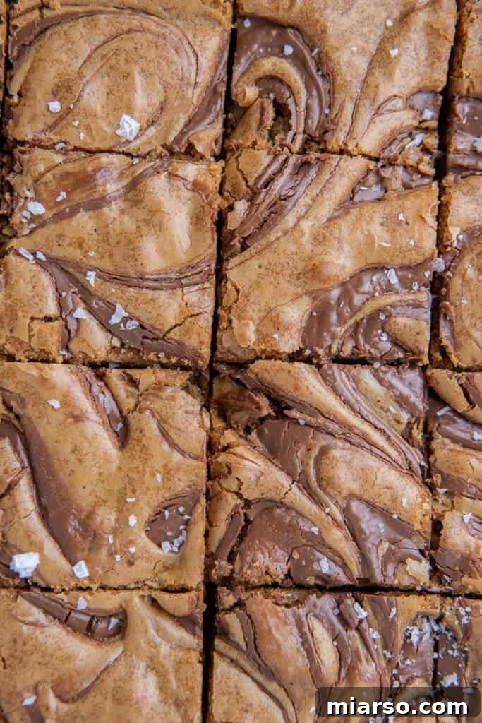 Decadent Nutella Swirl Blondies 10 A close-up of a single Nutella blondie, revealing its moist interior and perfect swirl patterns