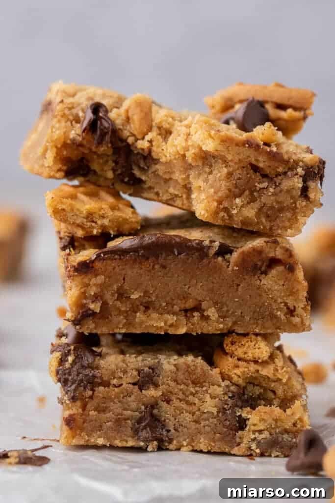 Close up of nutter butter cookie bars stacked, showcasing their rich texture and toppings.