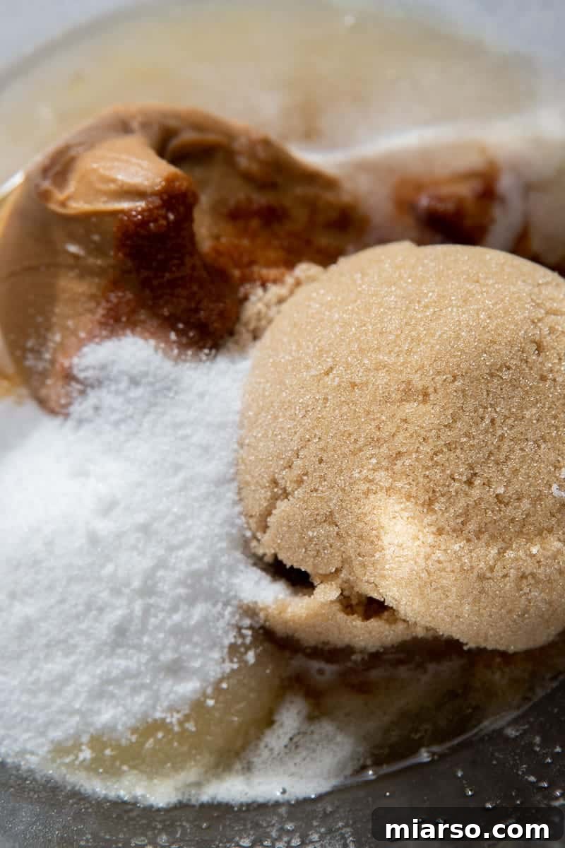 Wet ingredients (melted butter, sugars) in a mixing bowl.