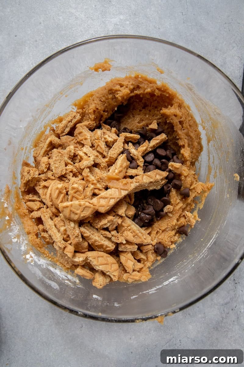 Cookie dough with peanut butter and chocolate chips in a bowl.