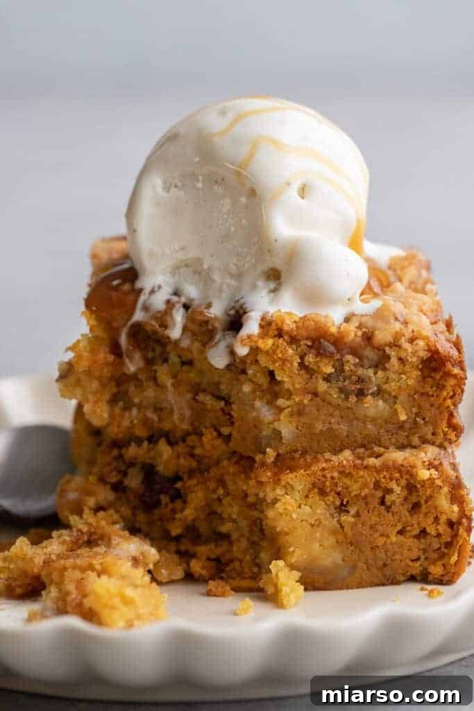 Decadent Pumpkin Crunch Cake served with a scoop of vanilla ice cream