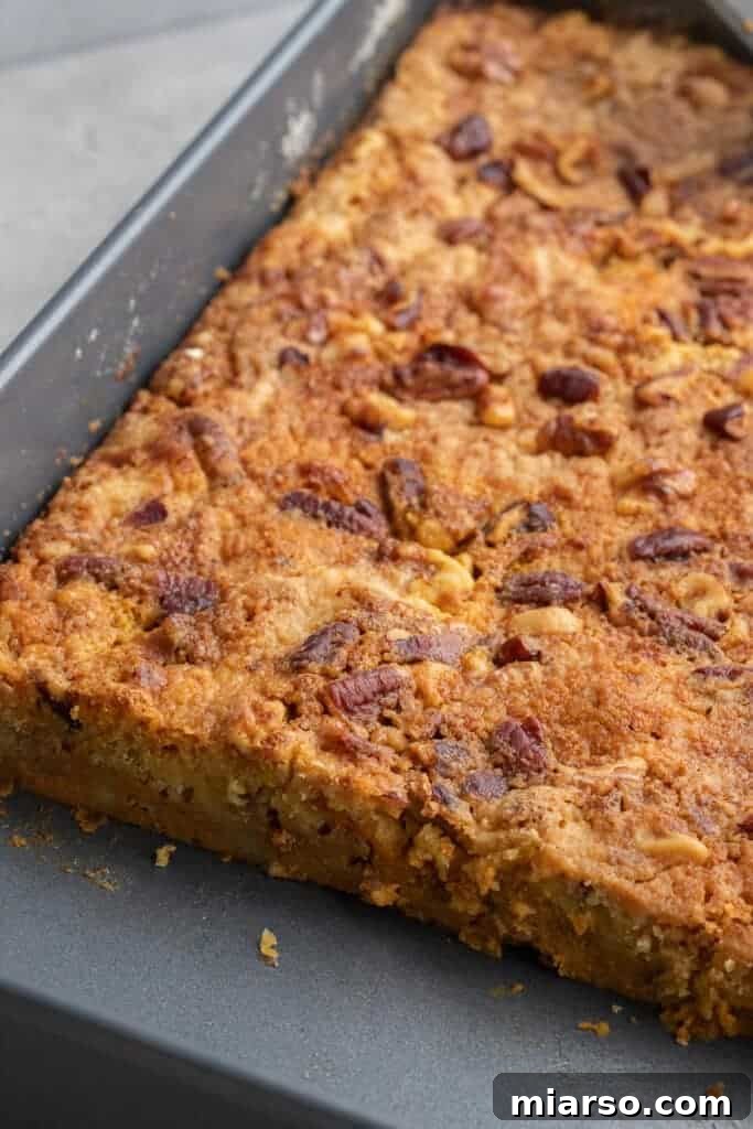 Baking pan of pumpkin and yellow cake mix dessert before baking
