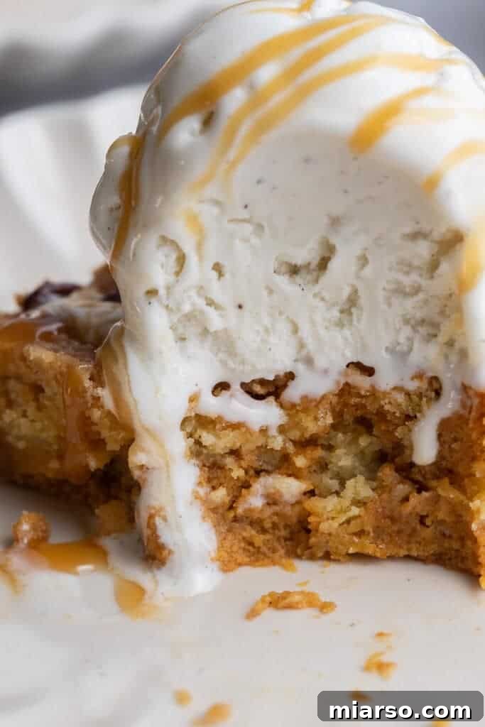 A close-up view of a slice of warm pumpkin cake with a crunchy topping