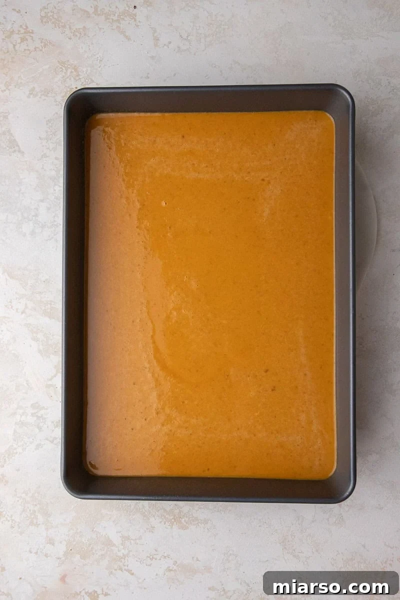 Pumpkin layer spread evenly in a baking pan