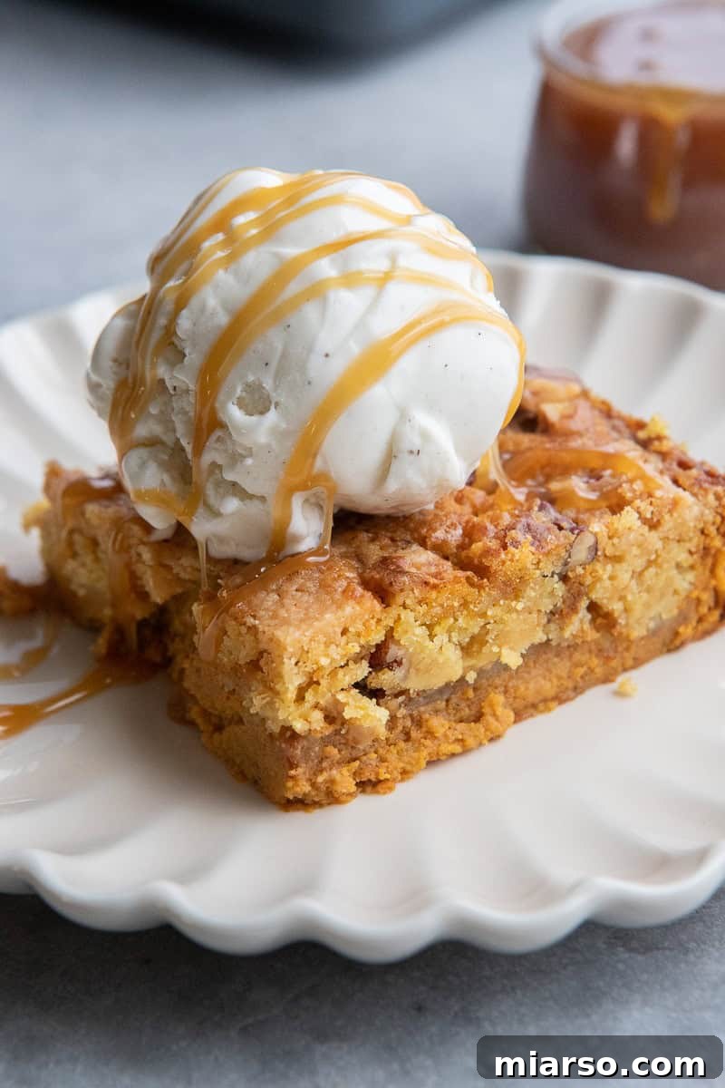 Finished Pumpkin Crunch Cake with ice cream and caramel drizzle