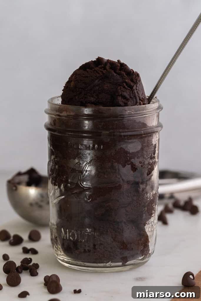 Edible brownie batter in a bowl with a spoon