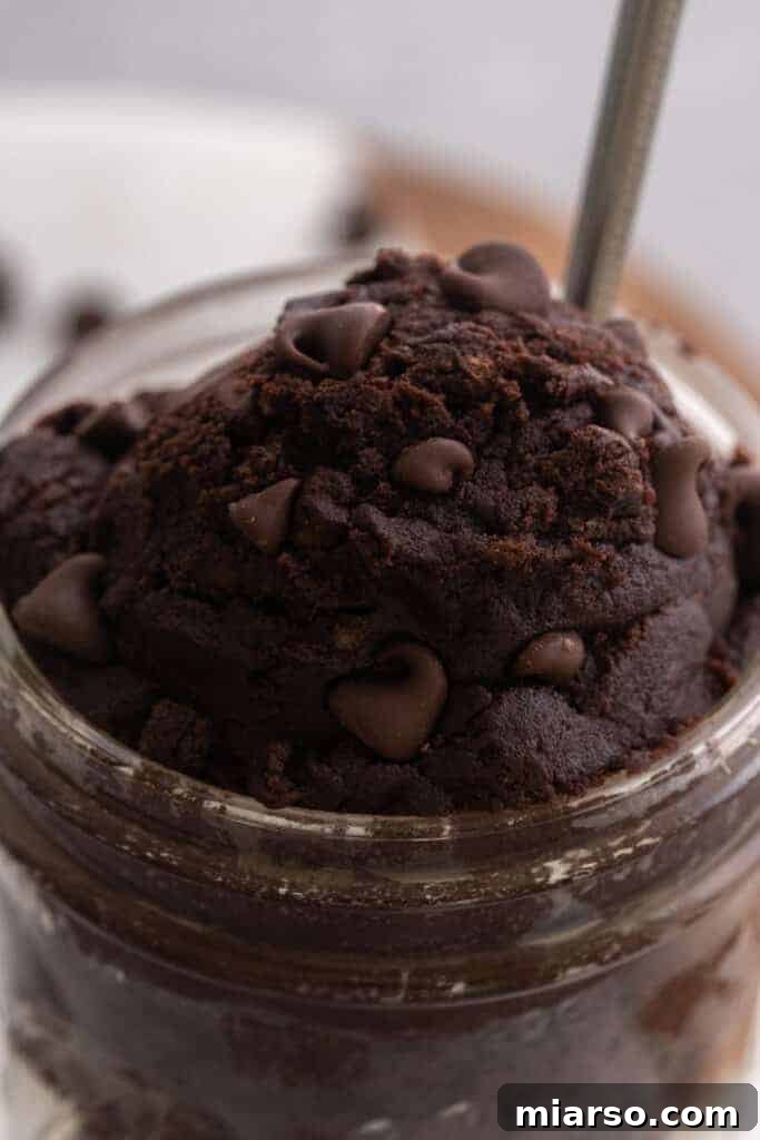 Scoop of edible brownie batter in a cup