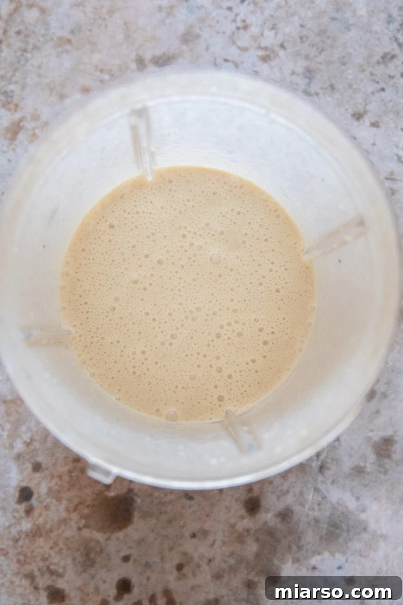 Frosty Peanut Butter Banana Pupsicles 6 Blender with mixed ingredients for dog treats