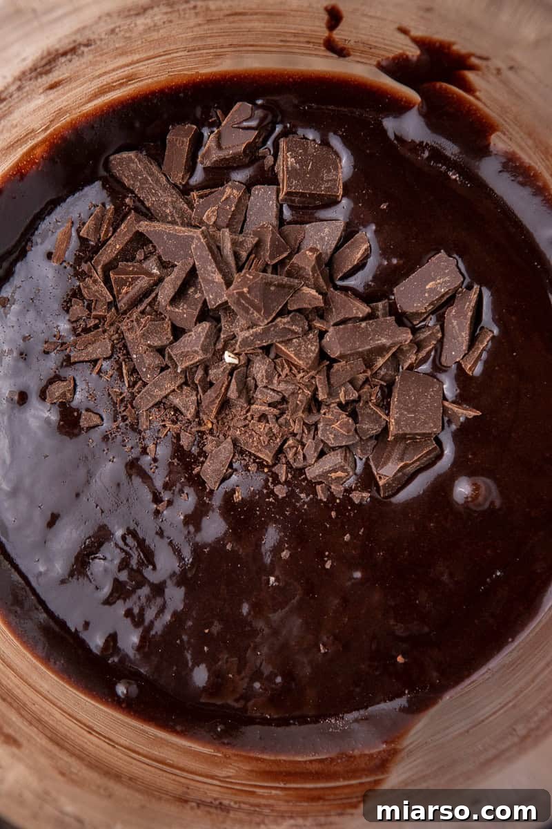 Chocolate chunks folded into brownie batter
