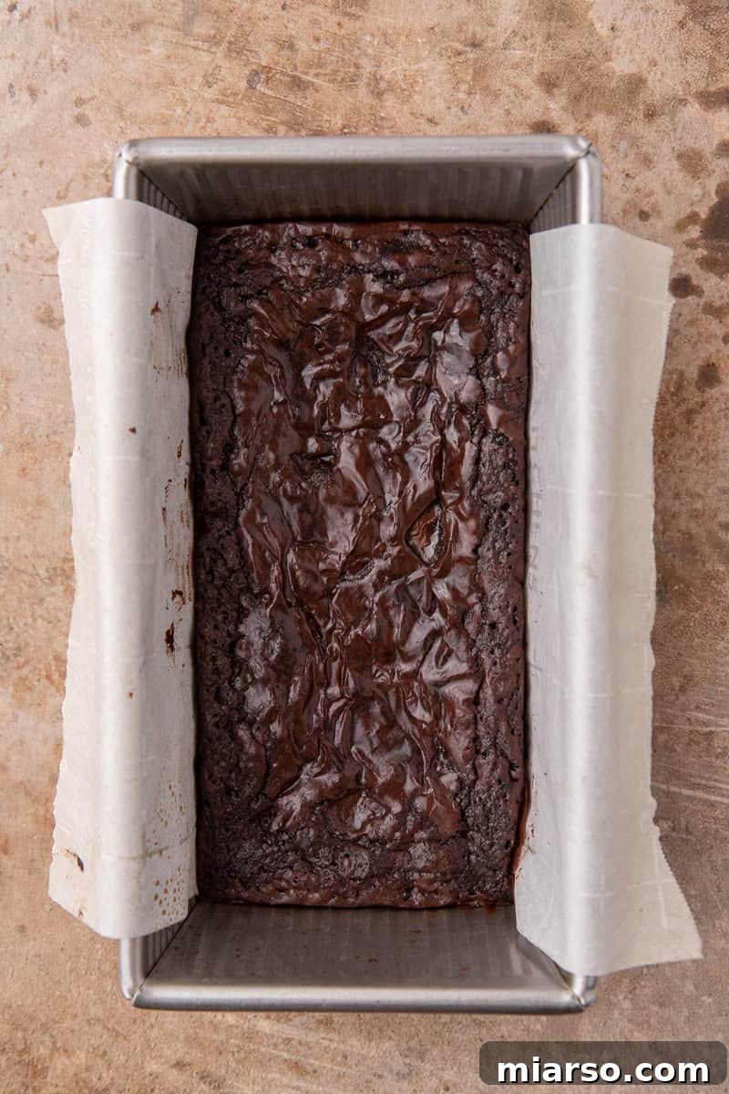 Baked small batch brownie with crinkly top in a loaf pan