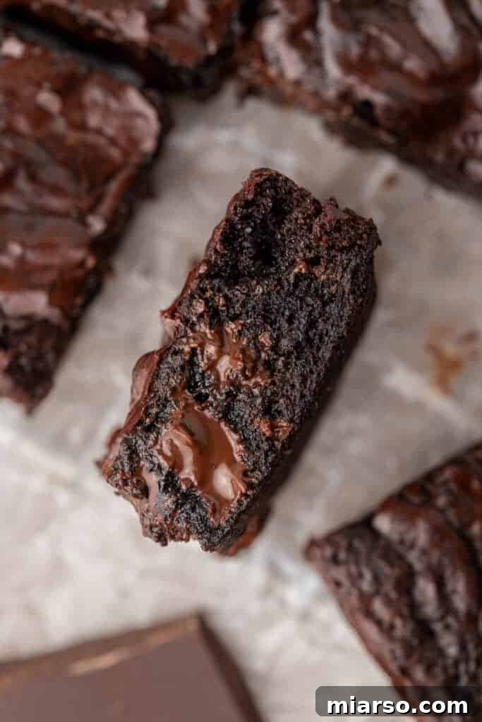 Overhead shot of a brownie piece with melted chocolate oozing out
