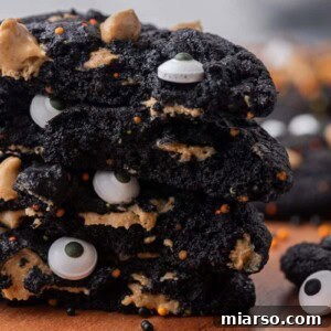 Close up of stack of black cocoa cookies with sprinkles and eyeballs