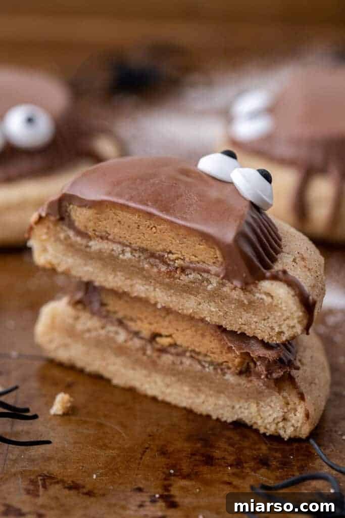 Spooky peanut butter cup cookies sliced in half and stacked