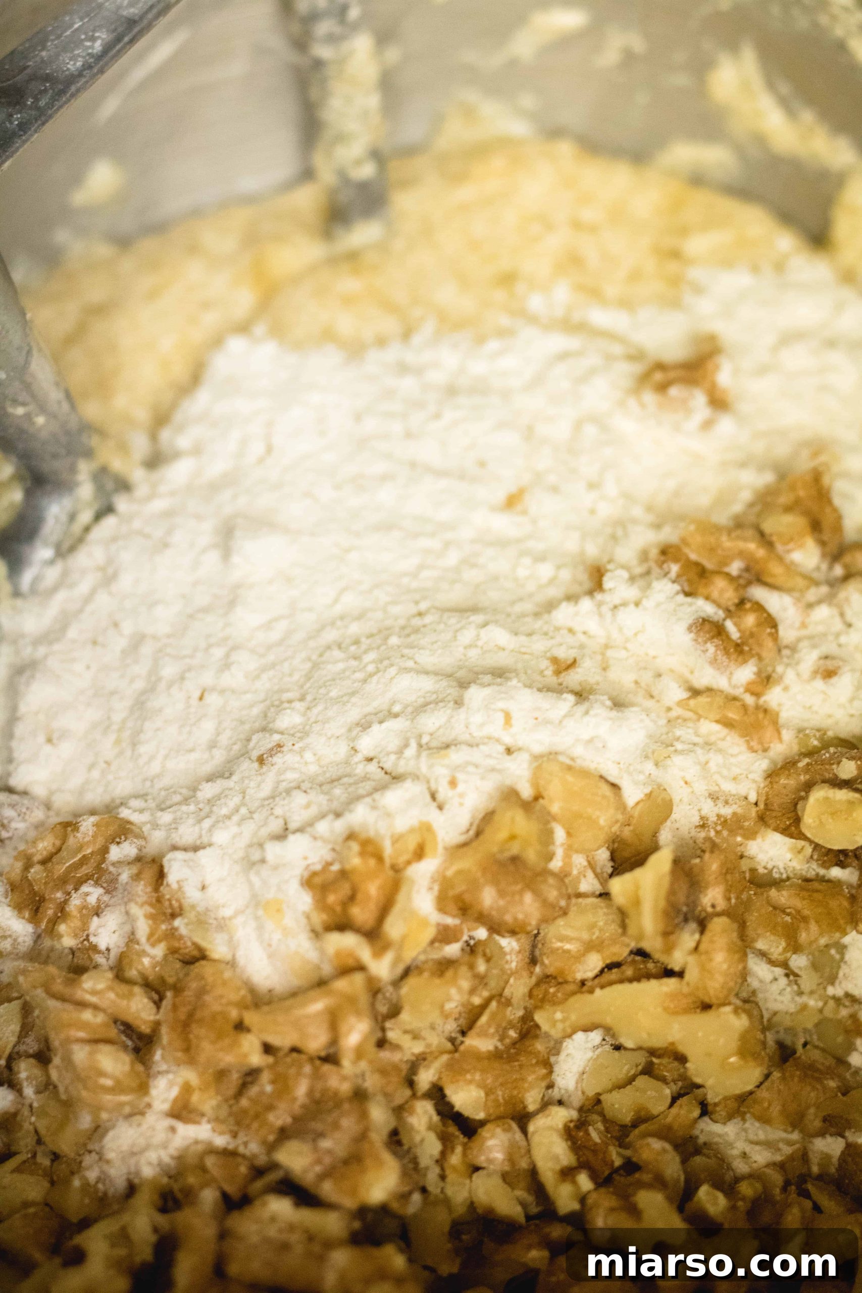Bakery-Style Banana Walnut Muffins 15 Adding dry ingredients and toasted walnuts to the wet banana muffin batter