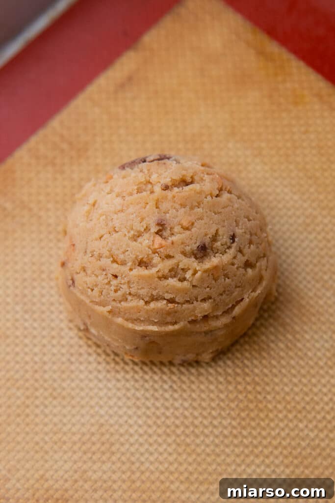 Ultimate Soft and Chewy Butterfinger Cookies 7 Scooped cookie dough ball on baking mat
