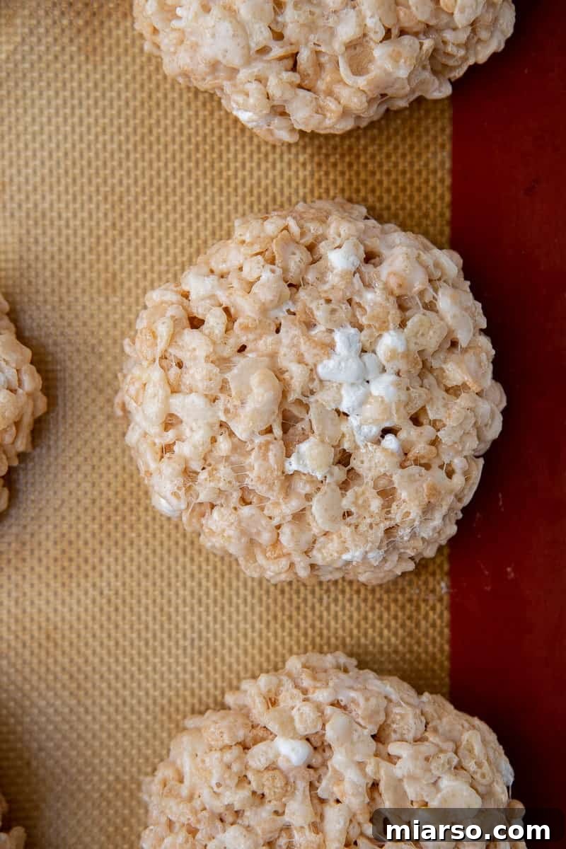 A baking sheet filled with perfectly formed no-bake rice krispies bar cookies, showcasing their golden hue.